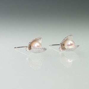 Side View of the Mini scallop shell stud earrings cast in silver with freshwater pearls inside by Hali MacLaren of HKM Jewelry