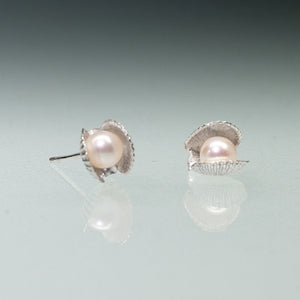 Mini scallop shell stud earrings cast in silver with freshwater pearls inside by Hali MacLaren of HKM Jewelry