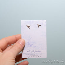 Load image into Gallery viewer, mini lemon shark teeth stud earrings cast in silver on a watercolor earring card by hali maclaren of hkm jewelry
