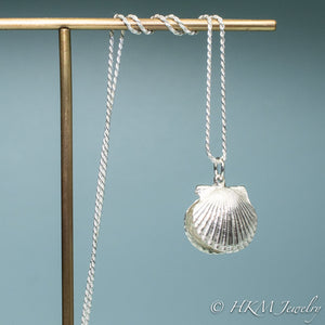 front view hanging on jewelry display bay scallop shell necklace with freshwater pearl in recycled silver by hkm jewelry