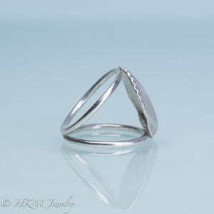 close up side view of large scallop shell ring on a split shank in sterling silver by hkm jewelry