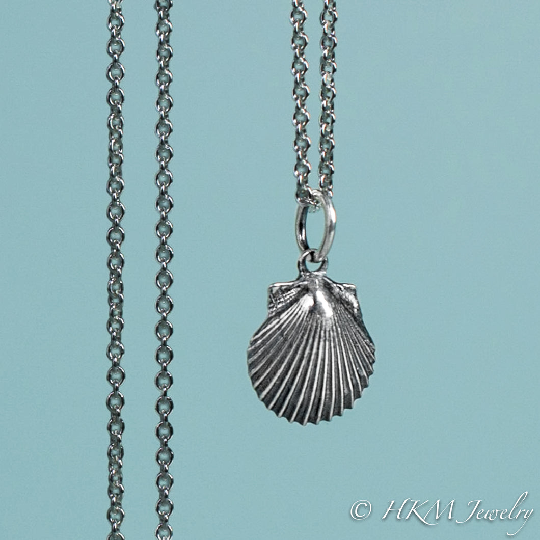 detail close up of small scallop shell necklace in oxidized sterling silver by hkm jewelry