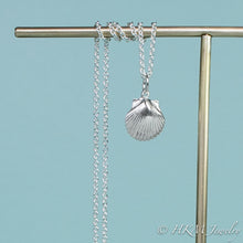 Load image into Gallery viewer, detail close up of small scallop shell necklace in polished sterling silver by hkm jewelry
