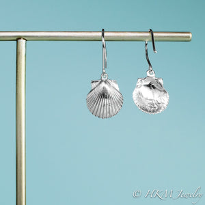 back and front view of the small polished scallop shell dangle earrings in sterling silver by hkm jewelry