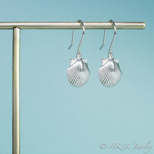 Load image into Gallery viewer, close up side view of the small polished scallop shell dangle earrings in sterling silver by hkm jewelry
