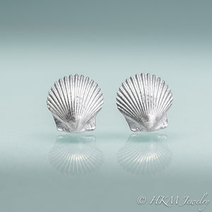 front view of small scallop shell studs in polished sterling silver by hkm jewelry