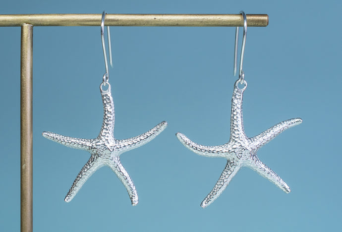 The Starfish Dangle Earrings cast in recycled silver